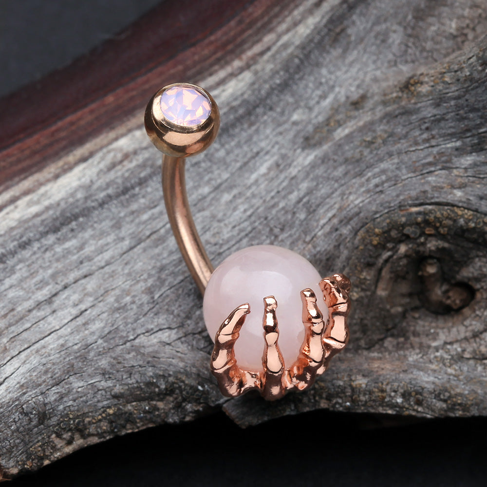 Detail View 2 of Rose Gold Rose Quartz Stone Orb Shine Skeleton Hand Belly Button Ring