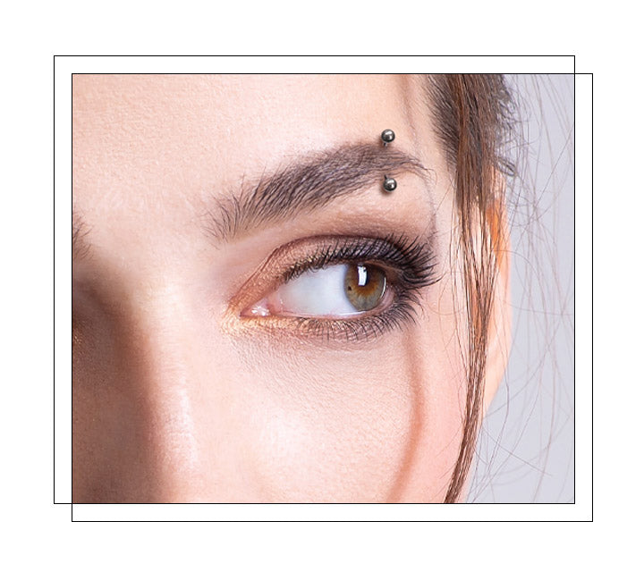Located above either the left or right eye, through the skin of the eyebrow. The most common location for an eyebrow piercing is from the outside corner of the eye at a 35-degree angle. It sits perpendicularly to the skin and has a separate entry and exit point, technically a surface piercing. There are five different types of eyebrow piercings: vertical, horizontal, nonstandard, multiple and anti-eyebrow piercings.