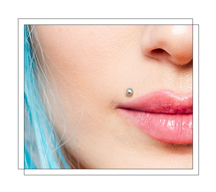 Located off-center lip piercing, placed above the upper lip. It is placed on the left-hand side to resemble Marilyn Monroe’s beauty mark, and a madonna piercing is the same, but only on the right-hand side. Both piercings are meant to emulate the beauty marks of their namesakes, these piercings characterize beauty. This piercing will highlight the lips and give anyone a unique sense of style!