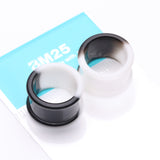 Detail View 3 of A Pair of Black and White Duo Tone Flexible Silicone Double Flared Tunnel Plug