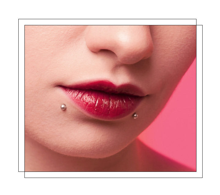 Two piercings located under the bottom lip: one if on the right side and one is on the left side. Other variations of snake bites include spider bites, angel bites, shark bites, dahlia bites, etc. They all depend upon where the piercings are placed in proximity to the lip. Known for its striking appearance, the name of the piercing comes from the look it gives you: as if you have the fangs of a snake, or as if a snake bit you!