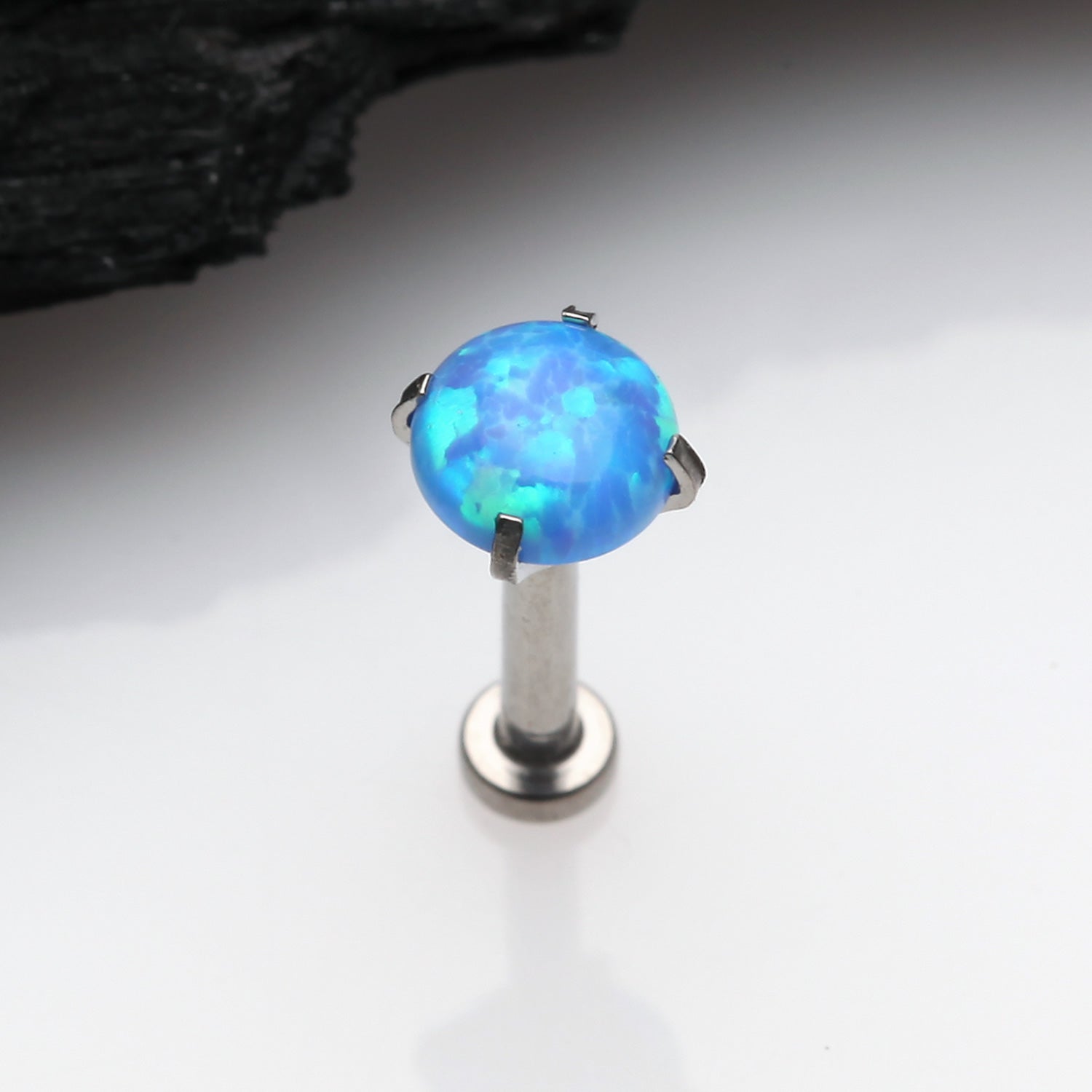 Detail View 1 of Implant Grade Titanium OneFit Threadless Fire Opal Prong Set Top Flat Back Stud Labret-Blue Opal