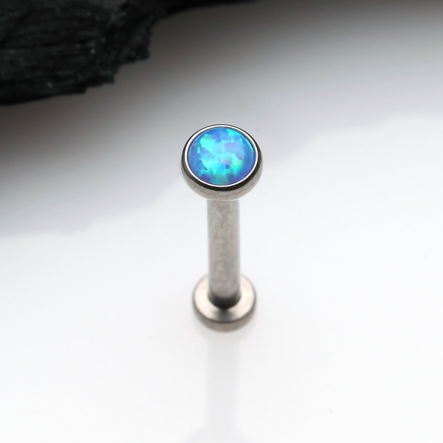 Detail View 1 of Implant Grade Titanium OneFit Threadless Fire Opal Bezel Set Top Flat Back Stud Labret-Blue Opal