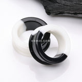 Detail View 1 of A Pair of Black and White Duo Tone Flexible Silicone Double Flared Tunnel Plug
