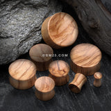 Detail View 2 of A Pair of Olive Wood Concave Organic Double Flared Plug-Orange/Brown