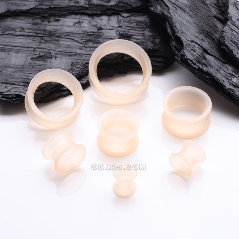 Detail View 3 of A Pair of Peach Tone Flexible Silicone Double Flared Tunnel Plug