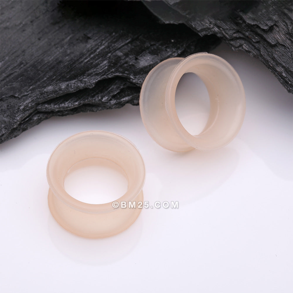 Detail View 1 of A Pair of Peach Tone Flexible Silicone Double Flared Tunnel Plug
