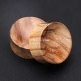 Detail View 1 of A Pair of Olive Wood Concave Organic Double Flared Plug-Orange/Brown